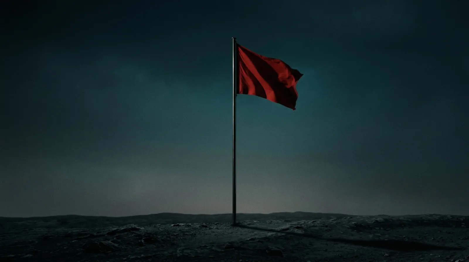 A single red flag fluttering against an out-of-focus clinic backdrop